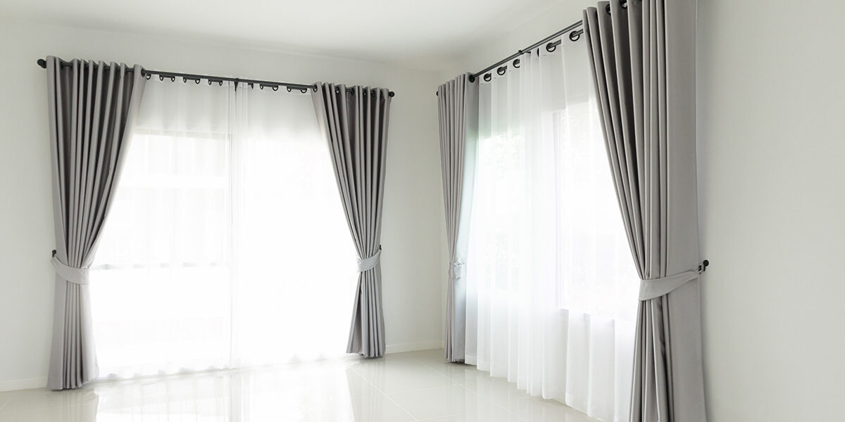 Curtains and drapes on large window, ideal for spacious interiors