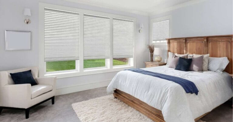 Cozy bedroom featuring energy-efficient cellular shades on the windows