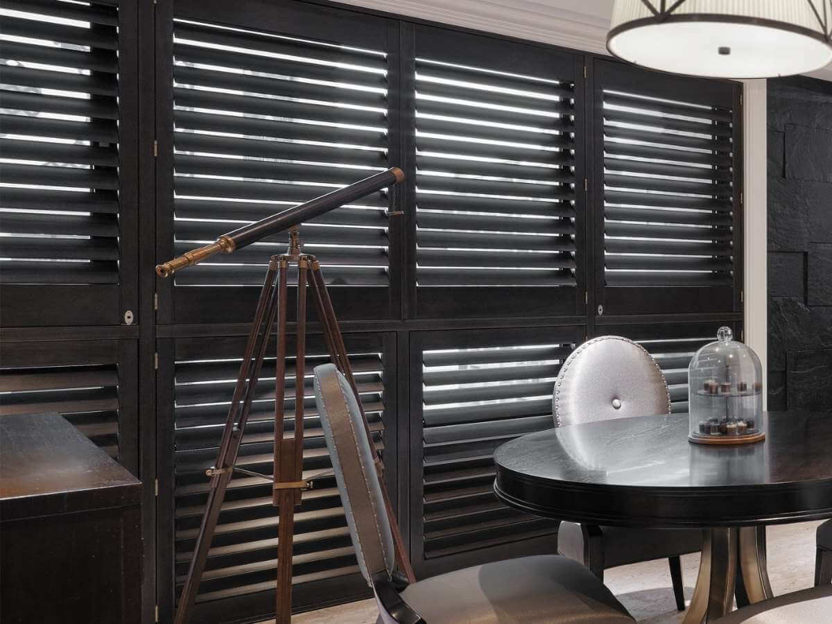 Black shutters make a statement. They create strong contrast against light walls and instantly add a touch of elegance.