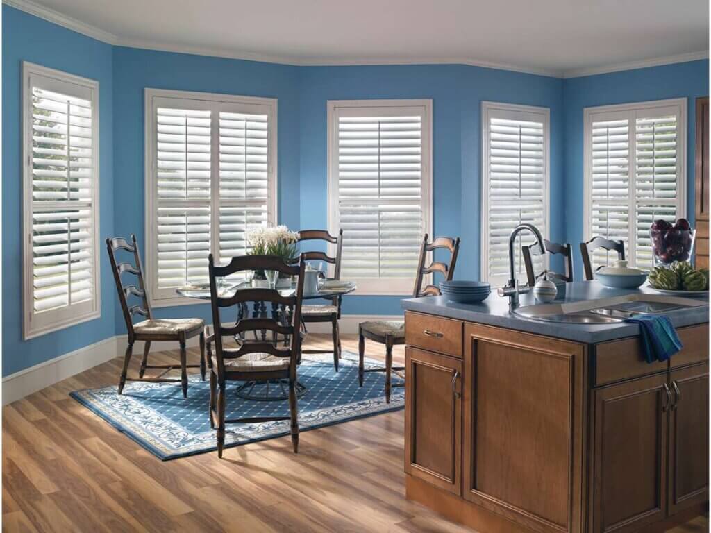 This is a photo of a composite shutters in a bay window in a kitchen and dining open living space