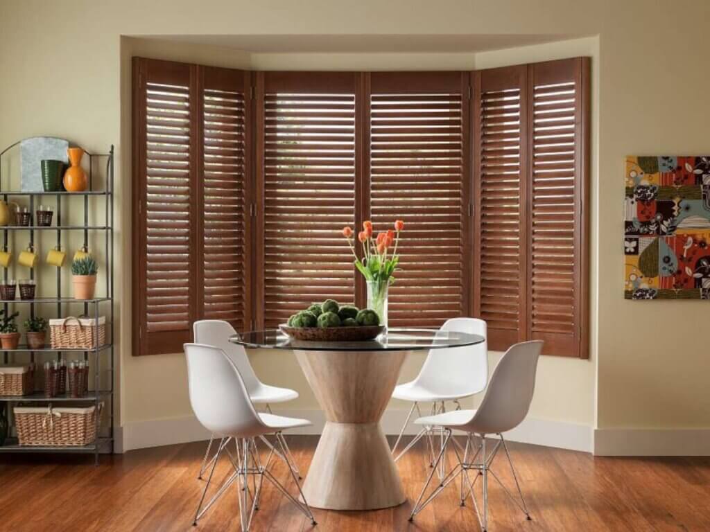 This is a photo of a wood shutter in a dining room